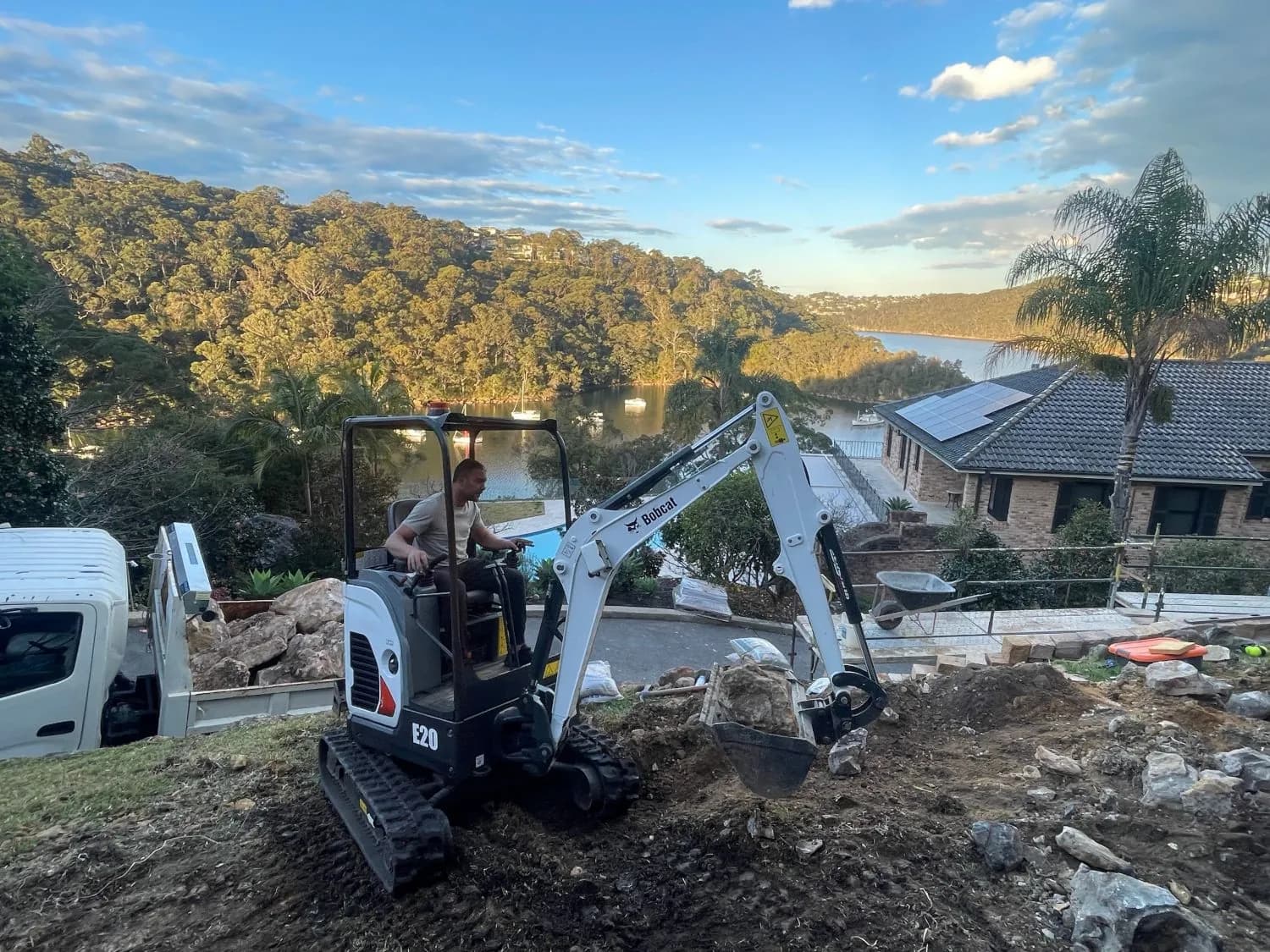 Mr. Clog excavator digging a trench at a waterfront property on Sydney's north shore at sunset